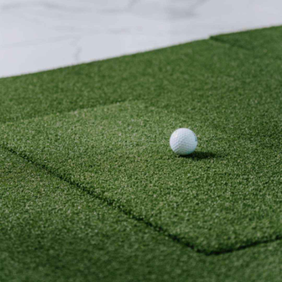 SIGPRO Softy hitting strip in mat with golf ball on top.