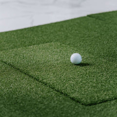 SIGPRO Softy hitting strip in mat with golf ball on top.